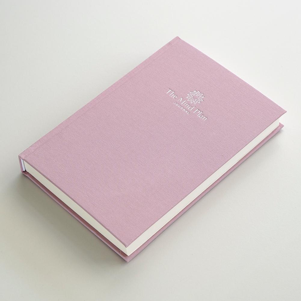 Close up of the pink linen journal on table